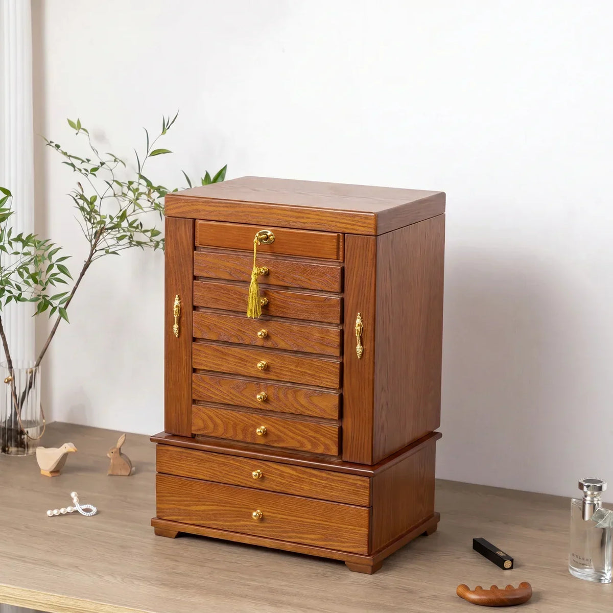 Close-up of vintage solid wood 10-layer carved jewelry box showing brass-tone hardware, velvet lining, and wood grain texture